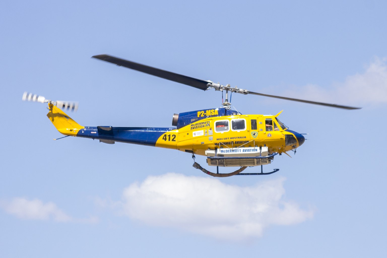 A McDermott Aviation Bell 214B, registration P2-MSA, fitted with a firefighting belly tank departing Wagga Wagga Airport in Australia