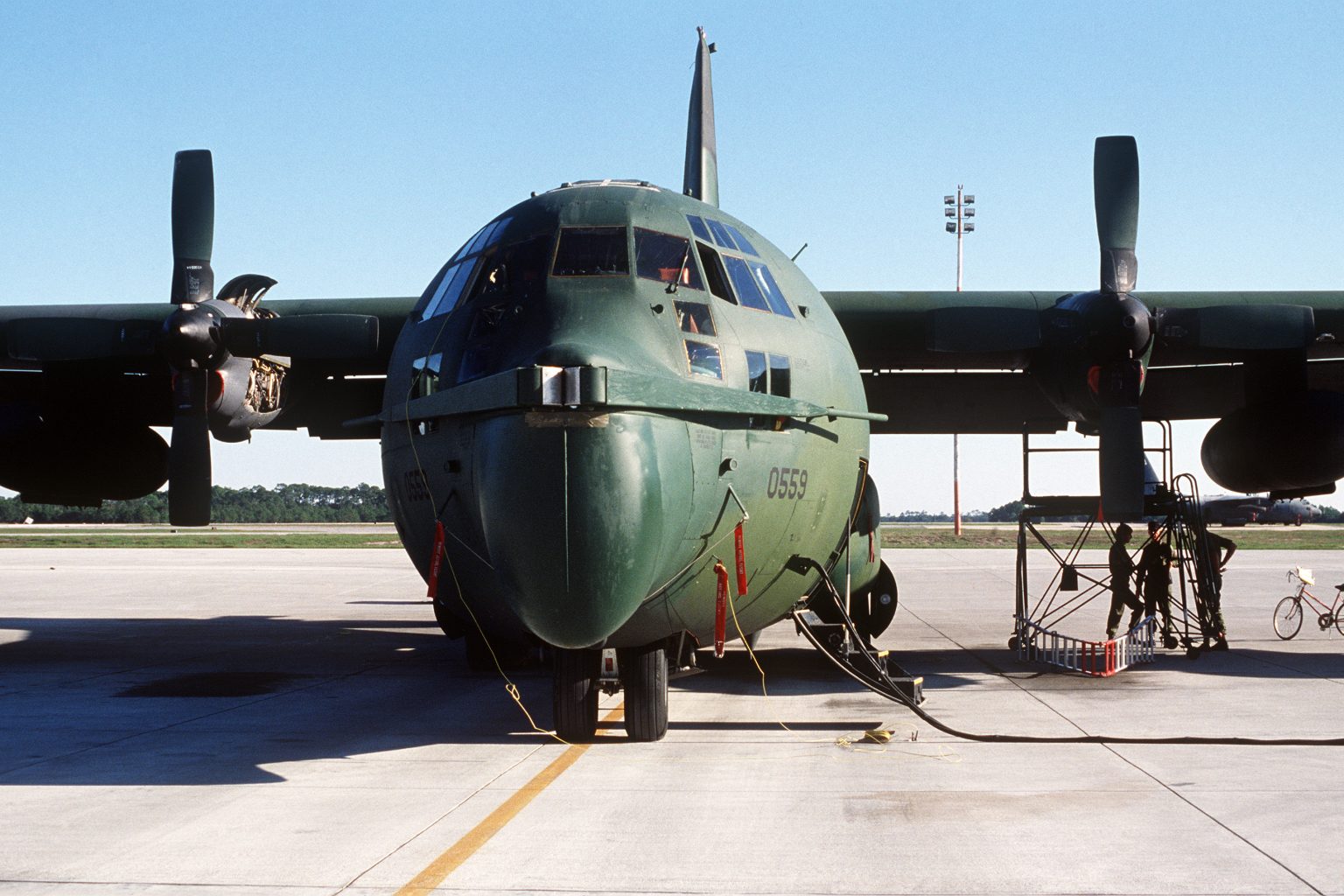 An MC-130 Hercules fitted with the V-shaped Fulton surface-to-air recovery yoke extending from its nose, the aircraft parked on a ramp