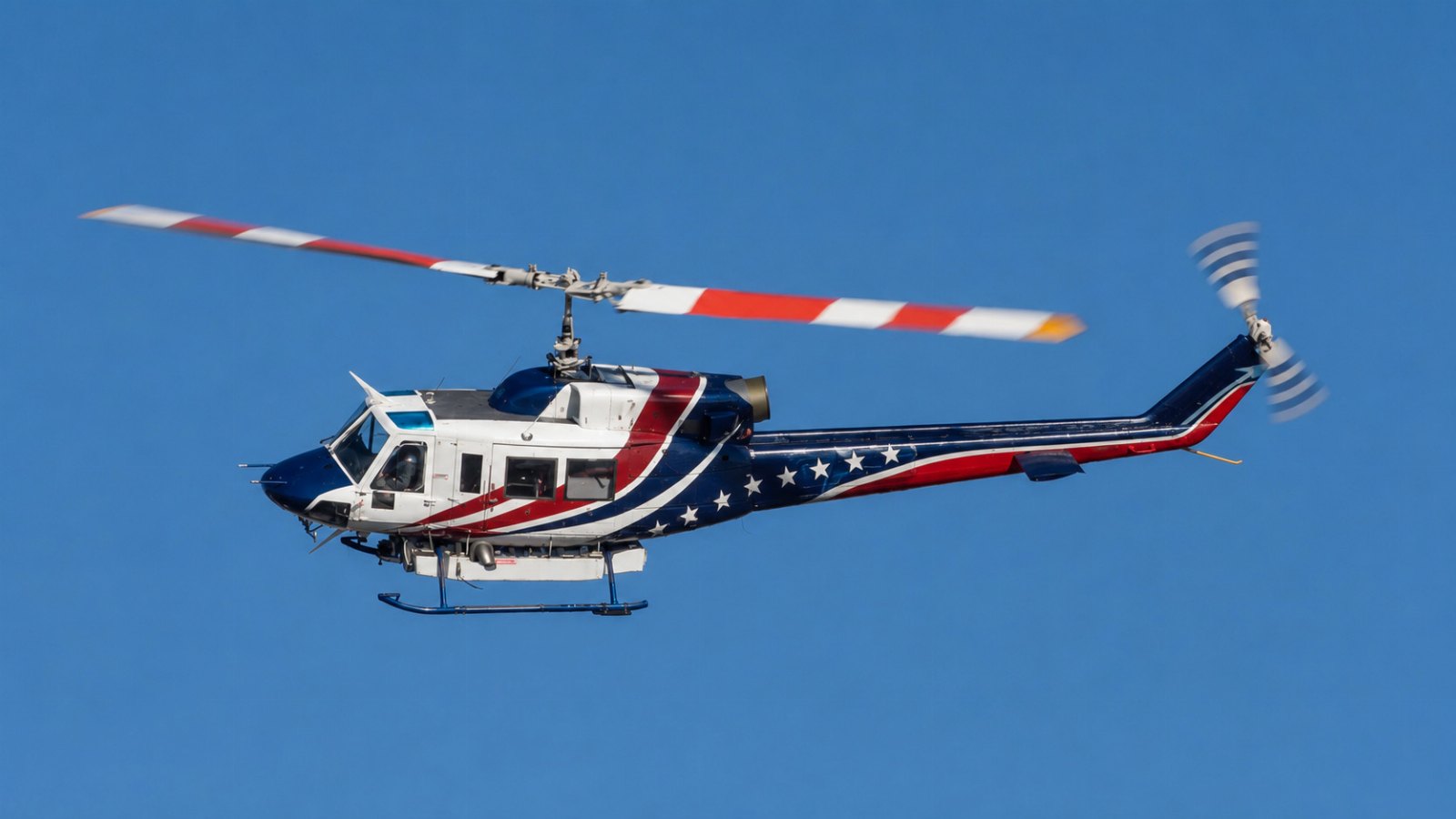 Bell 214B Big Lifter in flight showing single exhaust and wide-chord rotor blades
