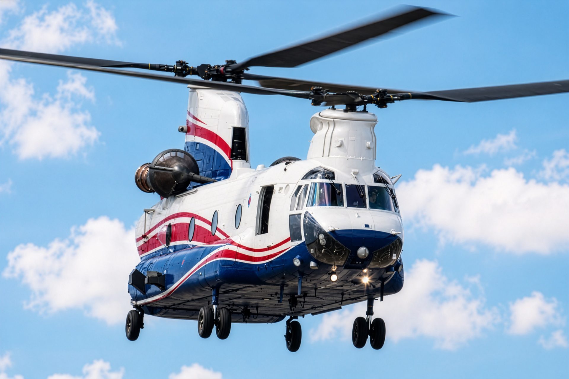 Tandem rotor Chinook helicopter in flight with full rotor arcs against open sky