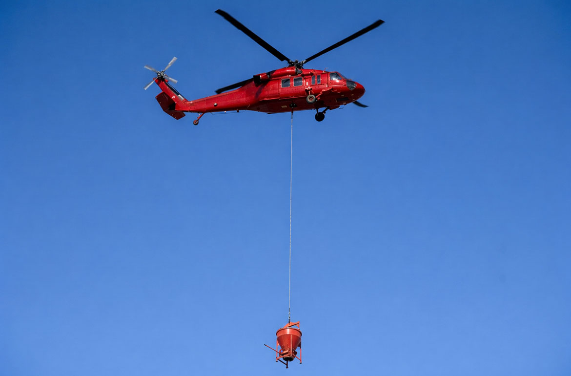 Helicopter concrete bucket delivery to a remote pour
